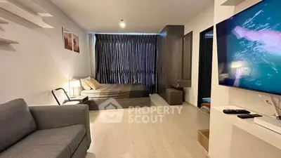 Modern studio apartment with cozy living area and stylish decor