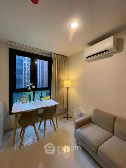 Cozy modern living room with dining area and city view