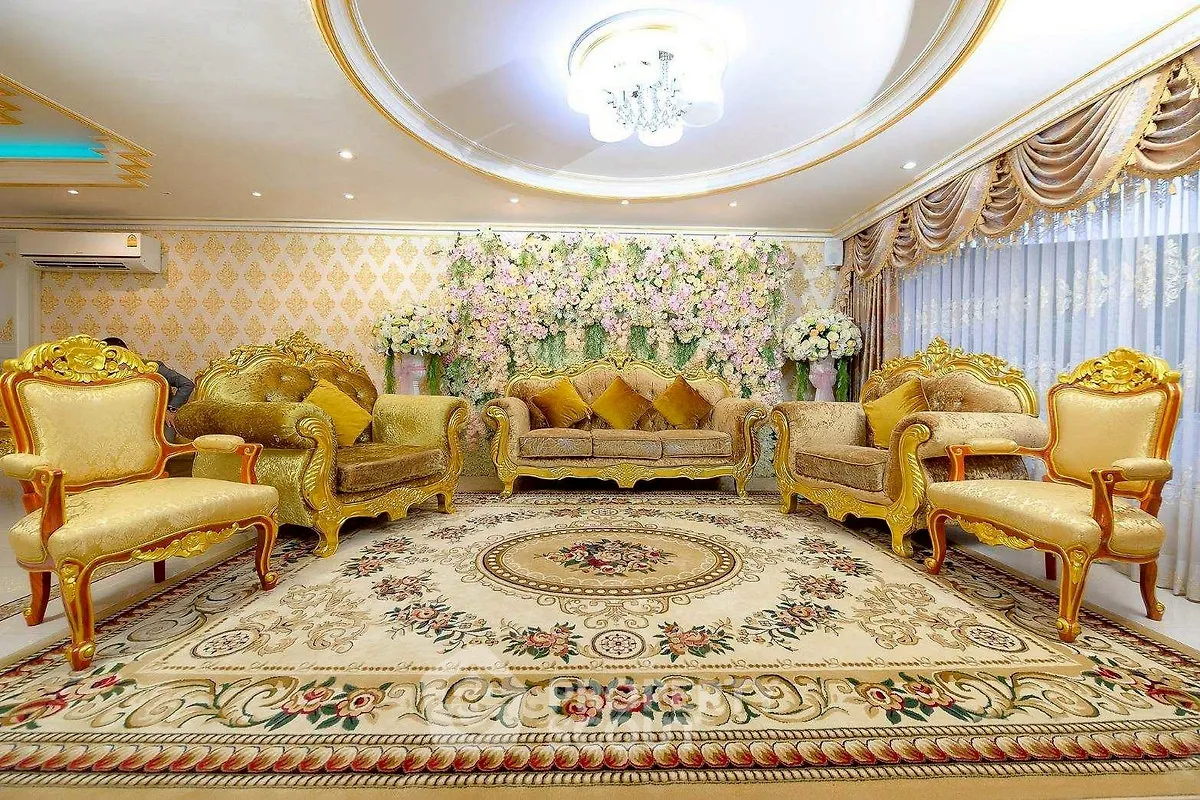 Luxurious living room with ornate gold furniture and floral decor