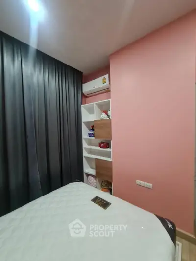 Cozy bedroom with modern decor, featuring a built-in shelf and air conditioning unit.