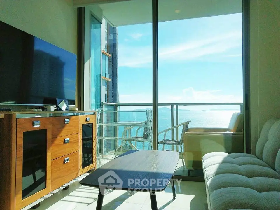 Stunning living room with ocean view and modern furniture in a high-rise apartment.