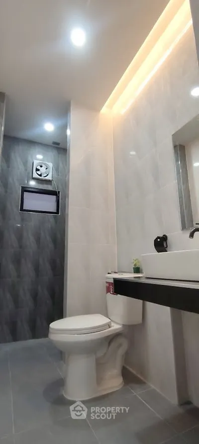 Modern bathroom with sleek gray tiles and contemporary fixtures