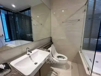 Modern bathroom with sleek fixtures and a luxurious bathtub in a contemporary apartment.