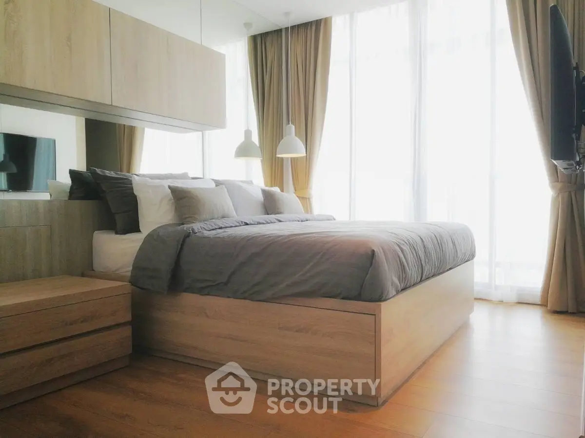 Modern bedroom with large windows and stylish wooden furniture
