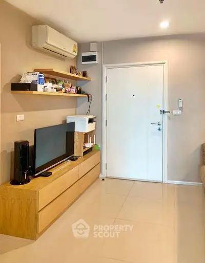 Modern living room with sleek furniture and air conditioning unit