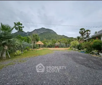Expansive garden with mountain view and lush greenery, perfect for nature lovers.