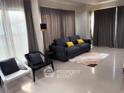 Spacious living room with modern furniture and large windows for natural light.
