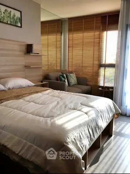 Cozy bedroom with natural light and modern decor, featuring a comfortable bed and stylish blinds.