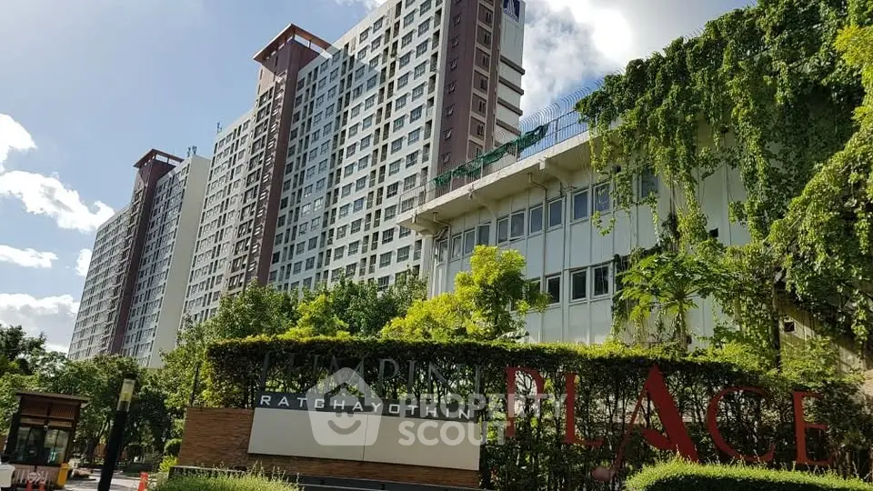 Modern high-rise condominium with lush greenery at Emporium Place Ratchayothin.