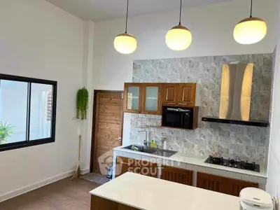 Modern kitchen with wooden cabinets and gas stove in bright interior