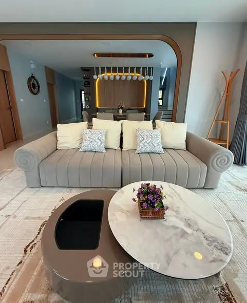 Luxurious living room with modern sofa and elegant coffee table in stylish apartment.