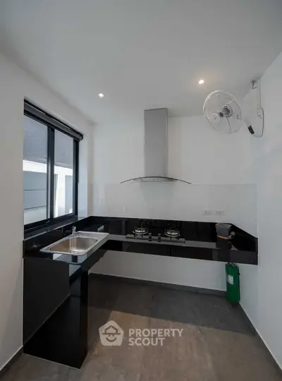 Modern kitchen with sleek black countertops and gas stove