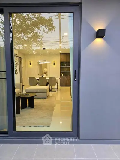 Modern living room with sleek glass door and stylish interior design