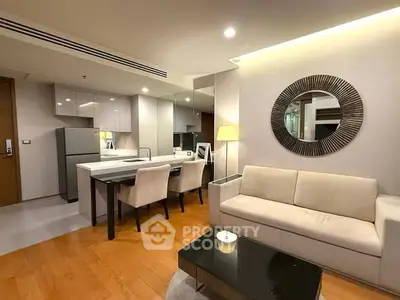 Modern living room with open kitchen, sleek furniture, and stylish decor