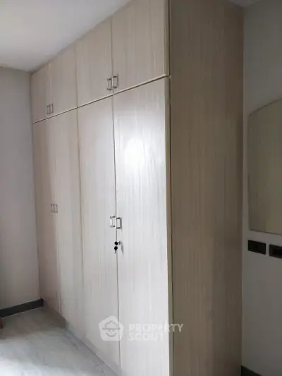 Spacious built-in wardrobe in modern apartment bedroom