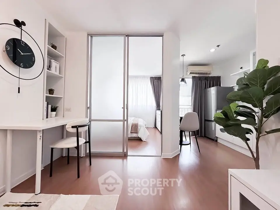 Modern apartment interior with open layout, featuring a stylish living area, bedroom, and kitchen with sleek design.