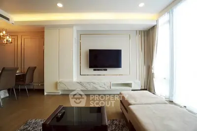 Modern living room with elegant decor and wall-mounted TV, featuring a cozy seating area and stylish dining space.
