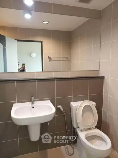 Modern bathroom with sleek fixtures and neutral tile design.