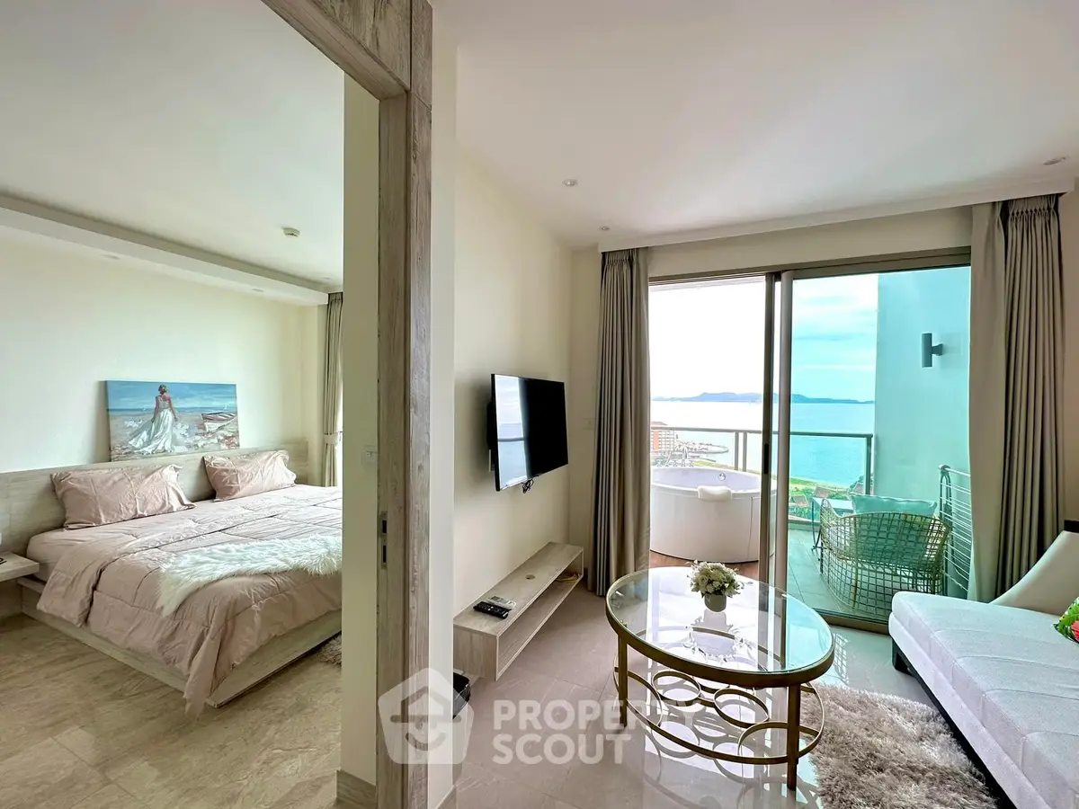 Luxurious condo with stunning sea view, spacious living room, and elegant bedroom, perfect for modern living.