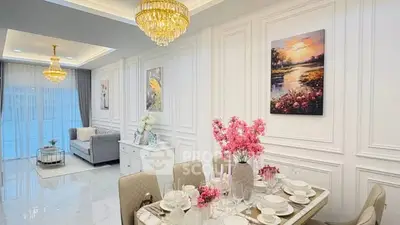 Luxurious living and dining area with elegant chandeliers and stylish decor