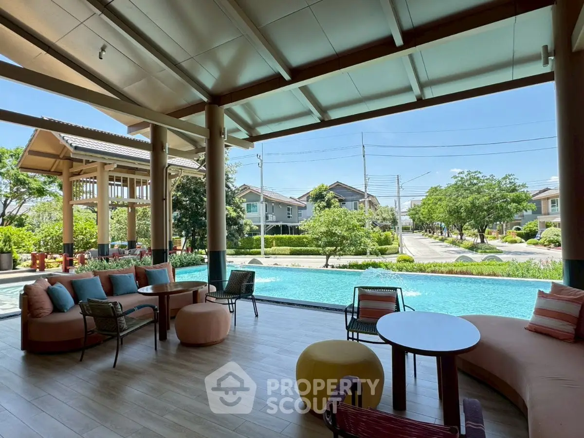 Luxurious poolside view with modern seating in a serene residential community.