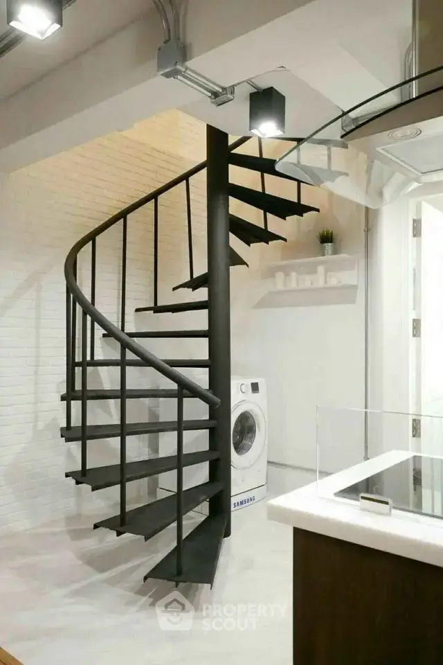Modern spiral staircase with sleek design and washing machine in stylish interior
