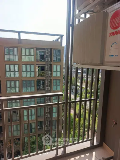 Modern apartment balcony with city view and air conditioning unit
