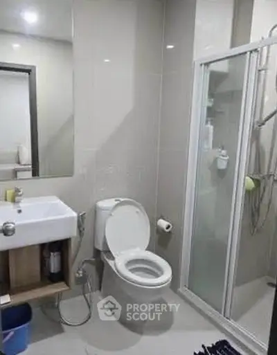 Modern bathroom with sleek shower and contemporary fixtures in a stylish apartment.