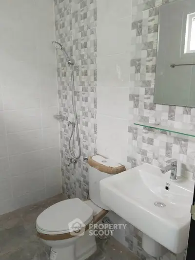 Modern bathroom with stylish tile design and sleek fixtures in a contemporary home.