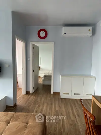 Modern apartment interior with wooden flooring and minimalist furniture