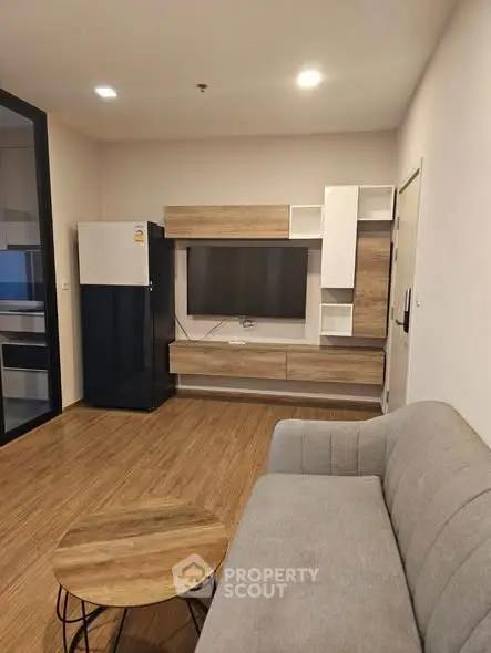 Modern living room with sleek furniture and wooden flooring