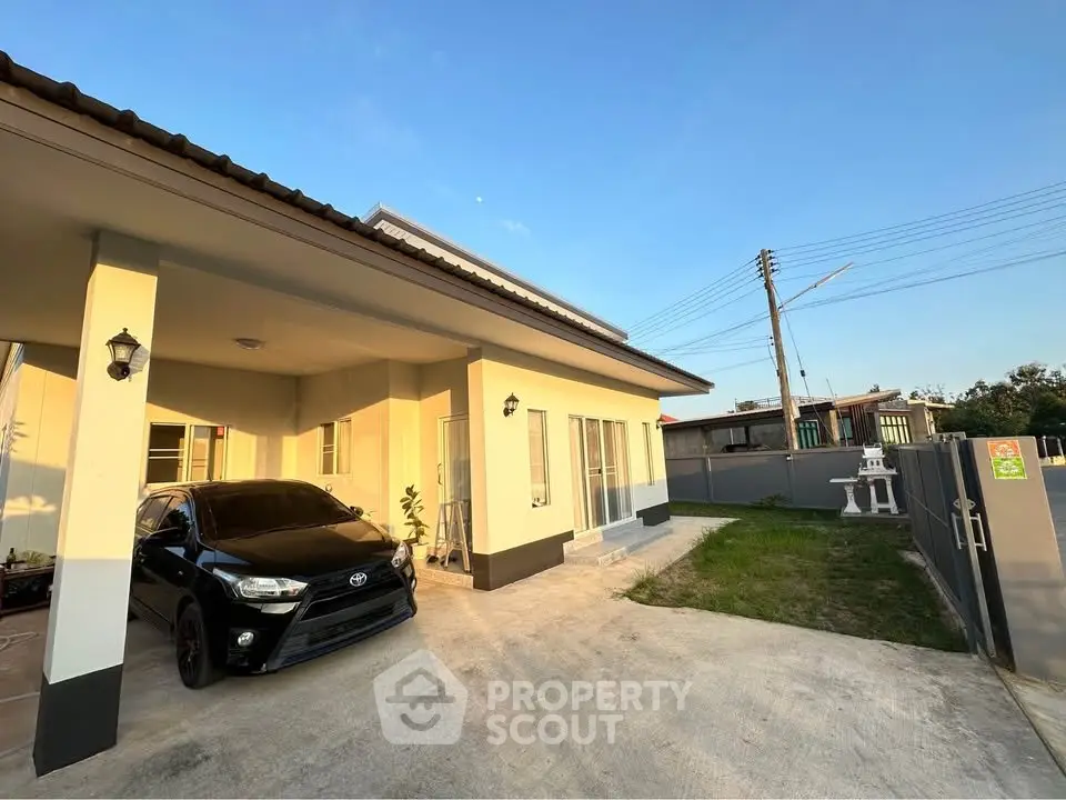 Charming single-story home with carport and spacious driveway in serene neighborhood.
