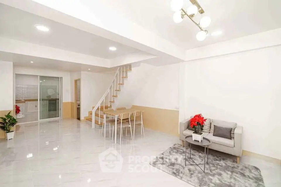 Spacious modern living room with sleek staircase and elegant decor