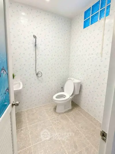 Bright and clean bathroom with modern fixtures and decorative tiles