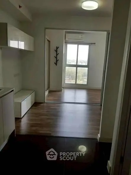 Modern apartment interior with sleek flooring and large window view