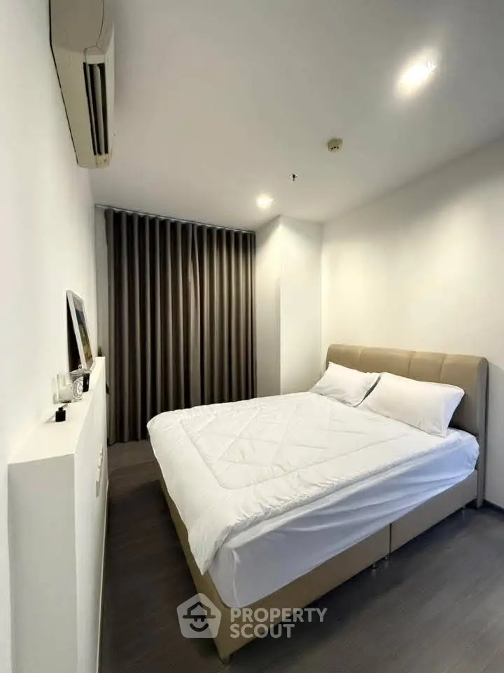 Modern bedroom with cozy bed and sleek design in a stylish apartment.
