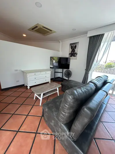 Spacious living room with leather sofa and modern decor