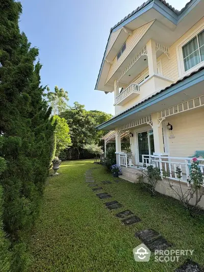 Charming two-story house with lush garden and inviting exterior