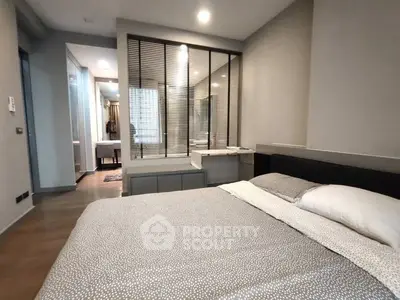 Modern bedroom with stylish decor and large window for natural light