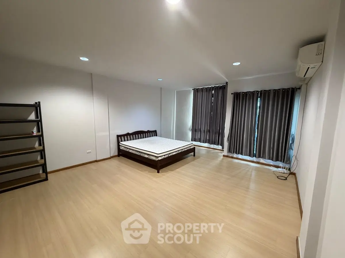 Spacious bedroom with minimalist design and ample natural light