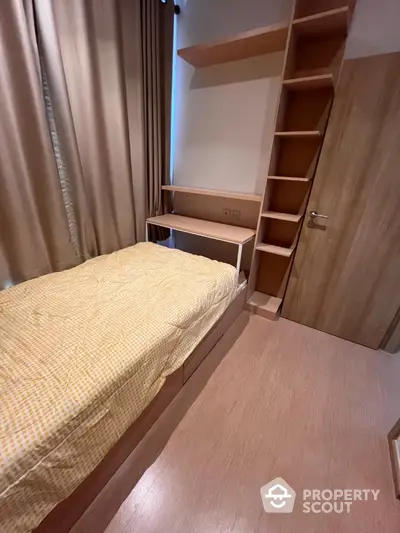 Cozy bedroom with built-in storage and wooden flooring