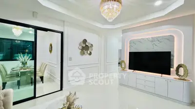 Luxurious living room with elegant chandelier and modern TV setup