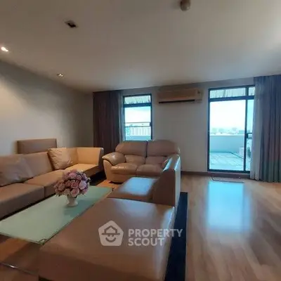 Spacious living room with modern furniture and balcony view