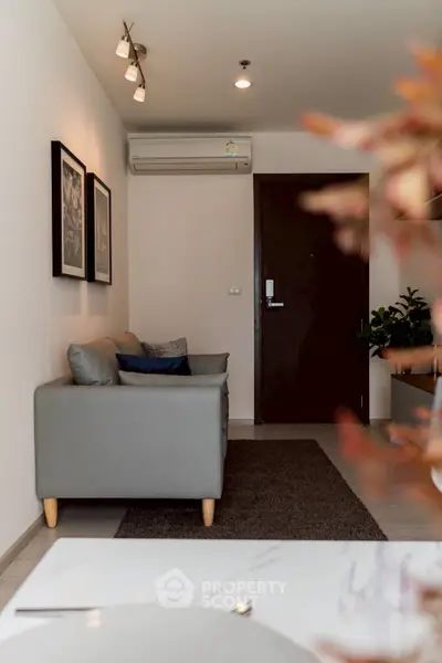 Stylish living room with modern decor and cozy seating in a contemporary apartment.