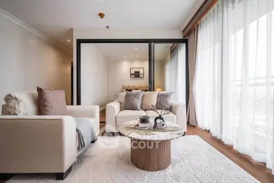 Luxurious living room with elegant decor and large windows offering abundant natural light.