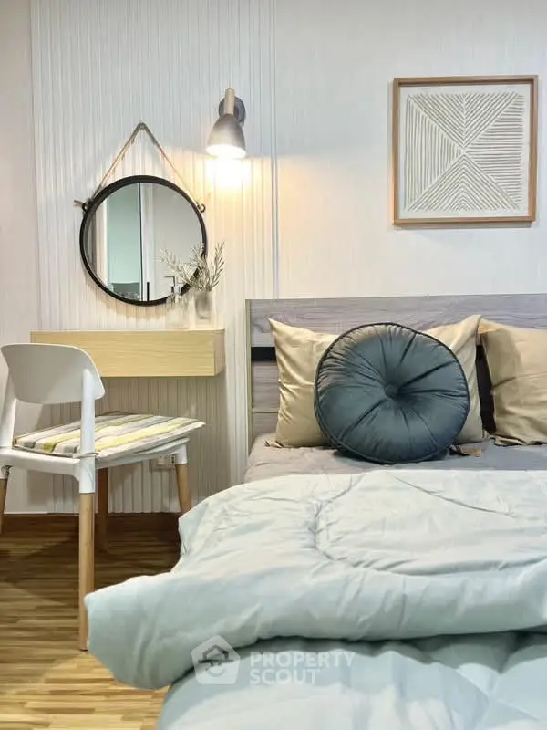 Cozy bedroom with modern decor, featuring a stylish mirror, wall art, and comfortable bedding.