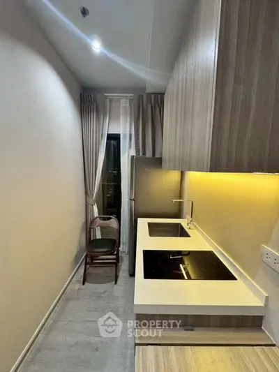 Modern kitchen with sleek cabinetry and built-in appliances in a compact layout.