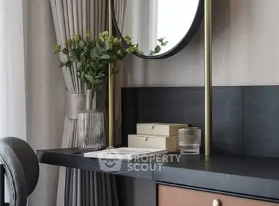 Elegant study area with modern desk, mirror, and decorative elements.