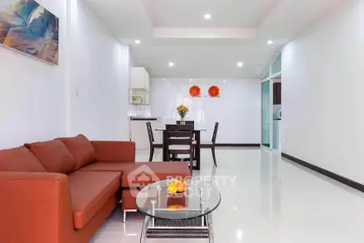 Spacious modern living room with red sofa and open kitchen layout