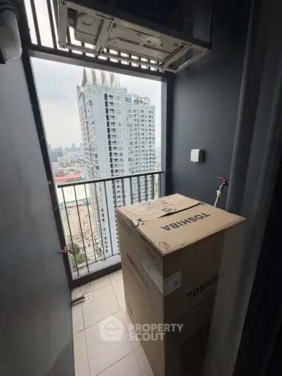 Compact balcony with city view and boxed appliance, ideal for urban living.